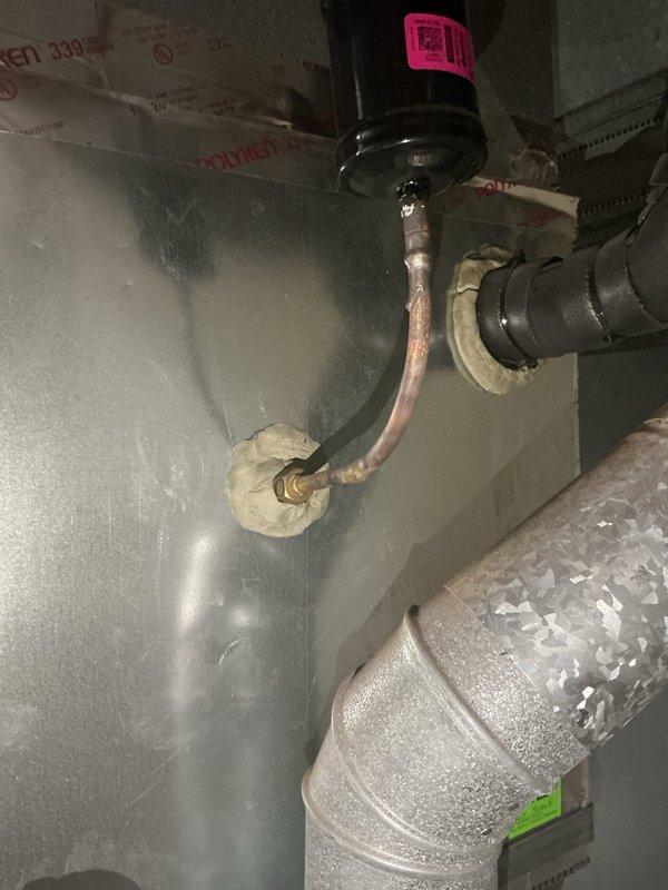 Responded to callback regarding refrigerant charge concerns from previous service visit. Customer questioned accuracy of prior technician's measurements indicating overcharge condition. Arrived during requested timeframe and performed complete system verification. Checked refrigerant pressures, superheat, and subcooling measurements at both indoor and outdoor units to confirm system charge status. Documented current thermostat settings showing 77°F display temperature and verified proper thermostat operation. Inspected refrigerant lines at air handler location, noting copper piping connections and insulation condition. Reviewed system operation and explained measurement methodology to address customer concerns regarding refrigerant charge assessment.