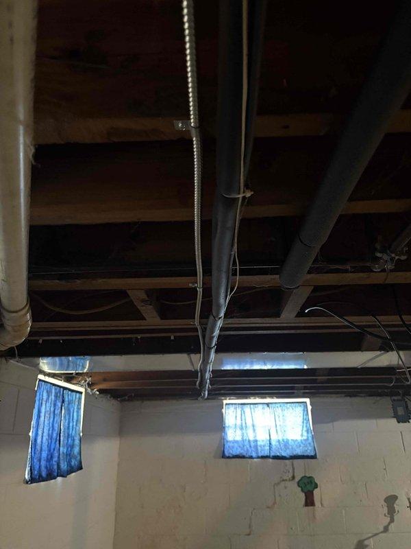 Responded to service call for newly installed photovoltaic system electrical issues causing repeated circuit tripping. Upon inspection, identified improper electrical installation in basement utility area where new PV system interconnection was affecting existing circuits. Traced electrical wiring through ceiling joists and verified proper conduit routing from basement to service panel. Corrected circuit protection issues, ensured proper grounding and bonding of electrical system, and verified all connections met NEC standards for PV installations. System tested and operational without further tripping incidents.