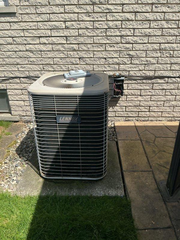 Provided comprehensive estimate for complete HVAC system replacement including air conditioning unit and natural gas furnace for 25-year-old equipment located in basement. The existing Lennox outdoor condensing unit is non-operational and requires replacement, while the furnace replacement is being quoted proactively due to age. Assessed current installation including outdoor unit positioning on concrete pad with gravel base against exterior brick wall, evaluated electrical service connections and metering configuration, and documented equipment specifications to provide accurate replacement options for both heating and cooling systems.
