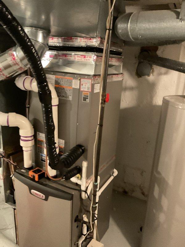 Completed installation of 3.5-ton air conditioning system with matching evaporator coil in right side yard location. Installed Lennox furnace with integrated coil assembly in basement mechanical room, established proper condensate drainage using PVC piping, and connected all ductwork including supply and return air plenums. Verified all refrigerant line connections, electrical wiring to outdoor condenser unit, and reconnected existing humidifier to new system for full operational functionality.