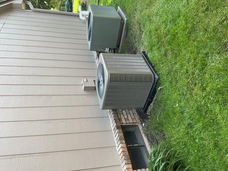 Completed full HVAC system installation including 45,000 BTU furnace and 1.5-ton air conditioning unit positioned in right side yard. Installed AC condenser on concrete pad with proper clearance, ran refrigerant lines and electrical connections through exterior wall with sealed penetrations, performed system flush, and reconnected all components. Obtained mechanical and electrical permits, verified system operation, and documented installation with photos showing outdoor condenser placement and wall penetration details.