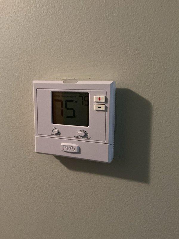 Responded to no cooling complaint on four-year-old air conditioning system located in basement. Upon arrival, verified thermostat was set to cooling mode at 75°F but system was not operating. Performed diagnostic evaluation of indoor and outdoor equipment, checking electrical connections, refrigerant pressures, and control circuits. Identified failed component covered under manufacturer warranty. Documented equipment conditions with photographs of basement mechanical room showing AC system location and thermostat settings for warranty claim processing.