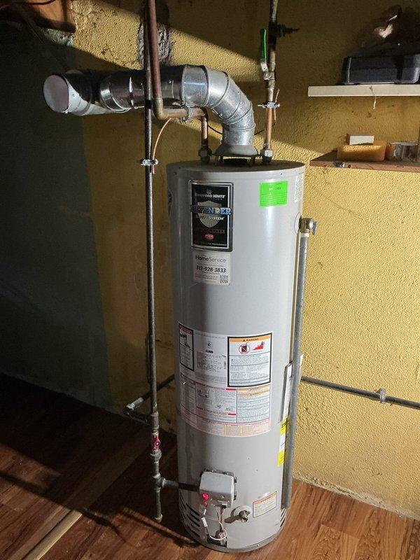 Installed 50-gallon short tank-style gas water heater in residential utility room. Connected all necessary water supply lines, gas piping, and exhaust venting with proper fittings and code-compliant materials. Installed drip pan with alarm system beneath unit for leak detection and prevention of water damage. Secured all piping with appropriate wall-mounted clamps and straps, verified proper clearances, tested all connections for leaks, and confirmed operational functionality of temperature controls and safety features.