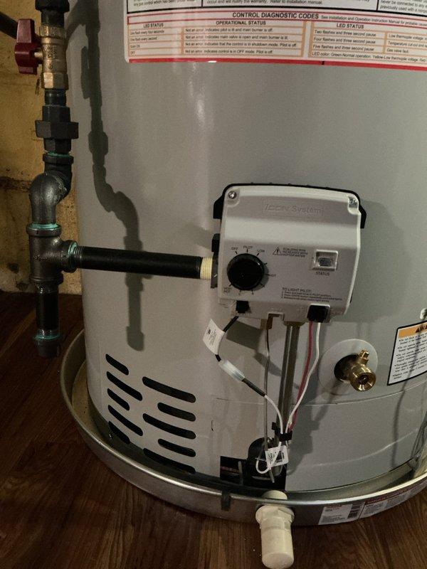 Installed 50-gallon short tank-style gas water heater in residential utility room. Connected all necessary water supply lines, gas piping, and exhaust venting with proper fittings and code-compliant materials. Installed drip pan with alarm system beneath unit for leak detection and prevention of water damage. Secured all piping with appropriate wall-mounted clamps and straps, verified proper clearances, tested all connections for leaks, and confirmed operational functionality of temperature controls and safety features.