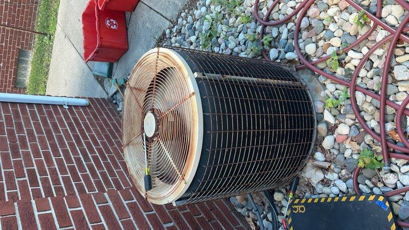 Responded to no-cooling complaint on residential air conditioning unit located at rear of property. Upon arrival, confirmed condenser fan motor was inoperative and system failed to engage cooling cycle. Performed diagnostic testing using clamp meter to verify electrical supply and measure amperage draw at outdoor unit. Found fan motor not receiving proper voltage due to failed run capacitor. Replaced defective capacitor with OEM-spec component rated for unit requirements. Verified proper amp draw of 13.1A on fan motor circuit post-repair. Tested system operation through complete cooling cycle, confirmed condenser fan engagement, and verified adequate airflow across condenser coil. System restored to normal operation with proper cooling output.
