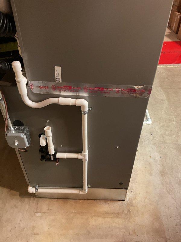 Completed installation of 4-ton air conditioning system with matching evaporator coil in rear configuration. Installed Lennox furnace unit in basement utility area with proper condensate drainage system utilizing white PVC piping with trap assembly. Reconnected all electrical and mechanical connections, performed system flush, and verified proper operation of all components upon completion.
