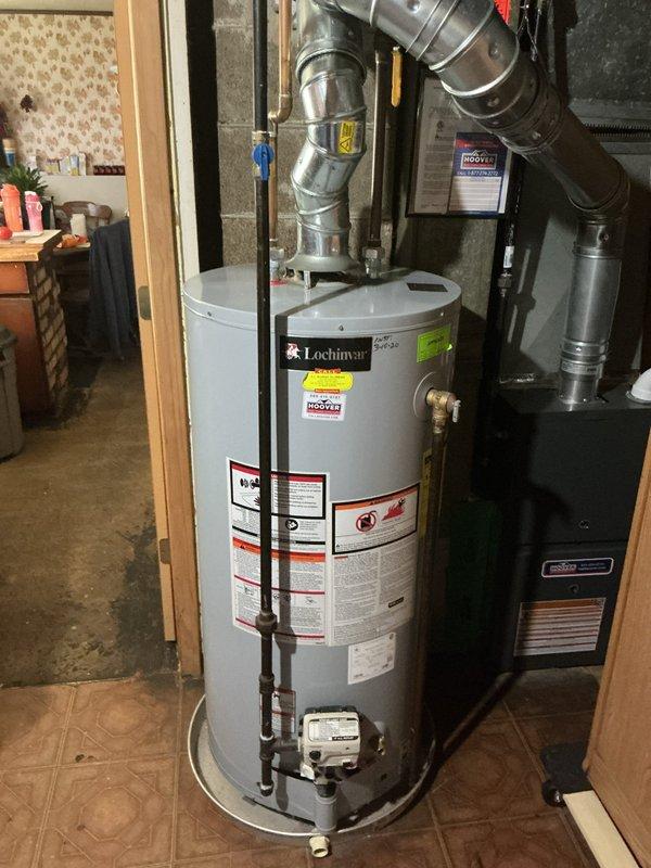 Responded to service call for loss of hot water in residential property. Upon inspection, found pilot light extinguished on five-year-old Lochinvar tanked water heater located on bottom floor. Successfully relit pilot light and verified proper flame operation and burner ignition. Tested hot water delivery at bathroom fixtures to confirm system restoration and full functionality throughout the home.