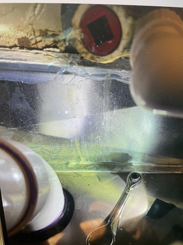 Responded to service call for water leaking from central air conditioning system onto furnace in basement. Upon inspection, discovered evaporator coil had severe ice buildup causing condensation overflow. Diagnosed frozen coil due to restricted airflow and improper drainage. Thawed evaporator coil, cleared condensate drain line, and verified system returned to normal cooling operation with proper drainage functioning.
