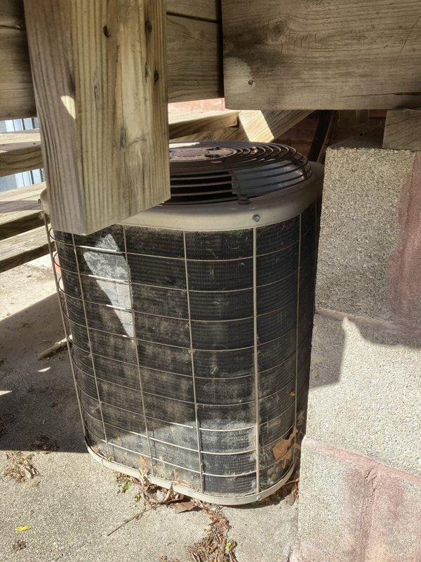 Responded to no cooling complaint for residential HVAC system with 22-year-old air conditioning unit and furnace. Upon inspection, confirmed refrigerant leak in aging system located with condenser in backyard and air handler in attic. Given the advanced age of the equipment, extensive wear visible on the outdoor unit including significant dirt accumulation, corrosion on protective cage, and overall deterioration, recommended full system replacement rather than repair. Provided comprehensive estimate for complete HVAC system upgrade to restore cooling capacity and improve energy efficiency for the home.
