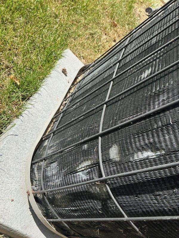 Completed yearly Gold AC maintenance inspection on residential cooling system. Unit was operating properly upon arrival. Performed comprehensive tune-up including inspection of outdoor condenser unit with protective wire guard, verified proper placement on concrete pad, checked condenser coils and fins for cleanliness and damage, examined electrical connections, tested refrigerant levels, and confirmed overall system operation. All components found in good working condition with no issues identified.