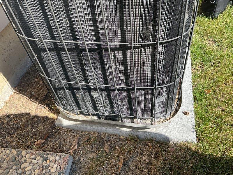 Completed yearly Gold AC maintenance inspection on residential cooling system. Unit was operating properly upon arrival. Performed comprehensive tune-up including inspection of outdoor condenser unit with protective wire guard, verified proper placement on concrete pad, checked condenser coils and fins for cleanliness and damage, examined electrical connections, tested refrigerant levels, and confirmed overall system operation. All components found in good working condition with no issues identified.