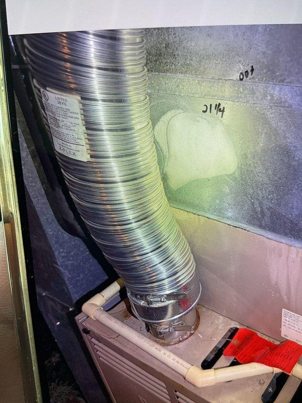 Responded to service call for non-operational cooling system with inoperative fan on 10+ year old YORK unit located on eastside of property. Upon arrival, discovered significant water accumulation at base of air handler indicating drainage system failure. Inspected condensate drain line and found complete blockage preventing proper drainage. Moisture patterns and discoloration on equipment panel confirmed ongoing condensation backup issue. Cleared condensate line obstruction and verified proper drainage flow. Tested system operation and confirmed fan motor and compressor cycling properly. System restored to normal cooling operation with adequate airflow throughout ductwork.