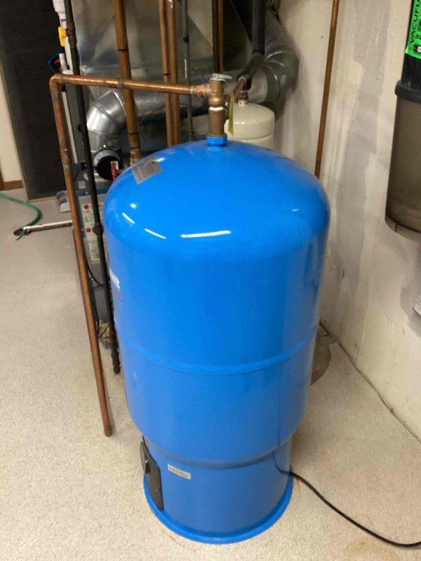 Provided estimate for indirect water heater installation in basement mechanical room. Evaluated existing hydronic heating system including expansion tank, circulation pump, and Boiler Mate pressure tank with associated copper piping and valves. Assessed current plumbing configuration and discussed indirect water heater integration options with existing boiler system infrastructure.