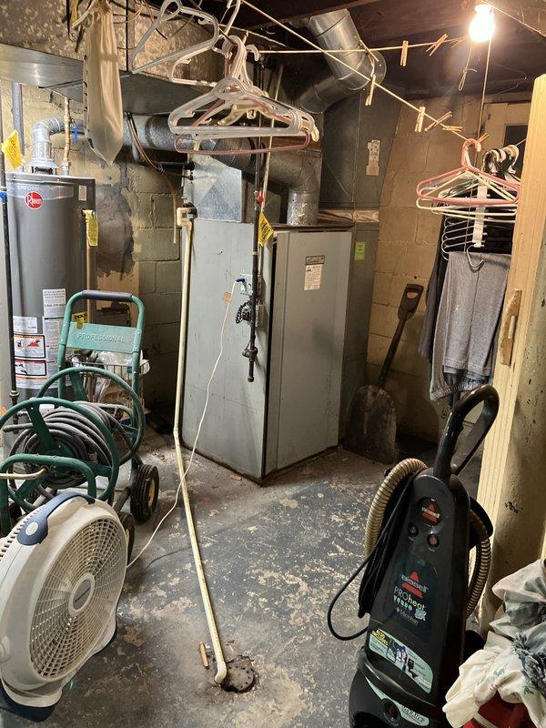 Responded to service call for air conditioning system not starting up in basement location. Evaluated 10+ year old cooling equipment and documented existing conditions of mechanical systems and utility area. Provided comprehensive replacement estimate for non-operational AC unit based on equipment assessment and site conditions.
