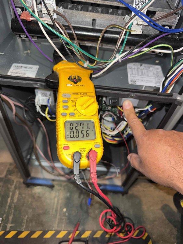 Responded to no cooling call on 25-year-old air conditioning system with fan operation but no cooling affecting entire residence. Upon arrival, performed diagnostic testing of outdoor unit and indoor air handler components. Utilized digital multimeter to test electrical connections, capacitor values, and control board functionality at the air handler. Measured voltage readings at control board showing 27.1V on low voltage circuit. Inspected refrigerant lines, ductwork connections, and all electrical wiring at indoor unit. Documented equipment condition with photographs showing air handler installation, ductwork configuration, and diagnostic measurements. Based on age of system and diagnostic findings, provided customer with assessment of unit condition and repair options. System requires further evaluation of outdoor condensing unit components including compressor operation, capacitor condition, and refrigerant charge to determine root cause of cooling failure.