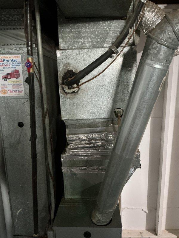 # HVAC System Evaluation and Estimate

Responded to service call for non-functional air conditioning system requiring full replacement assessment. Upon arrival, conducted comprehensive evaluation of existing HVAC installation located in confined utility closet space. Inspected current gray sheet metal air handler unit with connected flexible aluminum ductwork featuring S-shaped configuration. Noted existing system components including return air ductwork, wall-mounted return air grille, and electrical control wiring.

Performed thorough assessment of equipment condition, documenting significant dust and dirt accumulation on galvanized steel air handler exterior surfaces indicating extended operational use. Examined flexible ductwork connections, refrigerant line routing, and overall system configuration within tight installation space. Evaluated structural constraints of mechanical closet for replacement equipment specifications.

Photographed existing installation showing air handler 