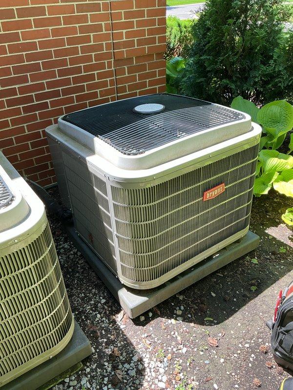 Completed Gold AC Inspection and routine maintenance on two Bryant air conditioning systems at residential property. Performed comprehensive tune-up including cleaning condenser coils, checking refrigerant levels, inspecting electrical connections, testing capacitors, and verifying proper airflow on both outdoor units positioned against exterior brick wall. Replaced furnace filters as requested and confirmed both systems operating within manufacturer specifications with no issues identified during inspection.