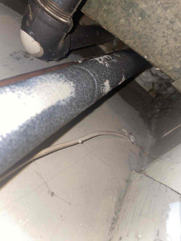 Conducted comprehensive assessment of existing heating and cooling system in residential utility closet for complete HVAC replacement estimate. Evaluated current natural gas furnace and air conditioning equipment configuration, including condensate drain assembly with PVC drainage lines, copper refrigerant lines with foam insulation showing frost accumulation indicative of temperature differential, and galvanized ductwork distribution system. Documented mechanical space conditions including water heater proximity, available clearances for new equipment installation, and utility area access constraints. Photographed existing system components, refrigerant line insulation condition, condensate management setup, and overall equipment layout to provide accurate replacement specifications for small residential application up to 1500 square feet.