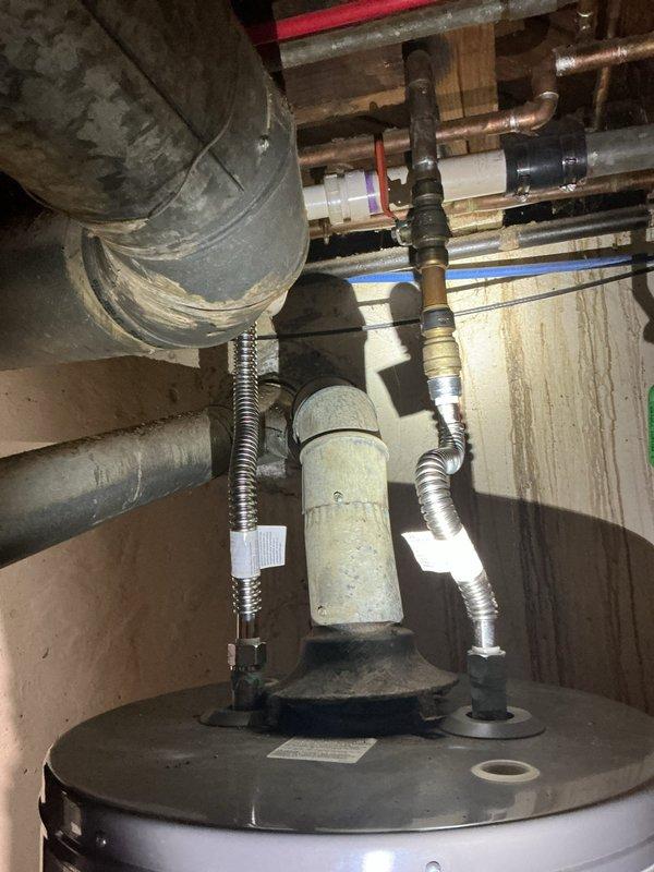 Responded to no hot water complaint at 70-year-old residential property. Upon inspection of basement-installed tanked water heater, diagnosed failed pilot light assembly preventing burner ignition. Verified gas supply to unit, inspected thermocouple and pilot assembly for proper function. Relit pilot flame following manufacturer specifications, confirmed burner ignition cycle, and tested temperature and pressure relief valve operation. Verified all supply and return connections, expansion tank mounting, and flue venting integrity. Restored hot water service throughout residence.