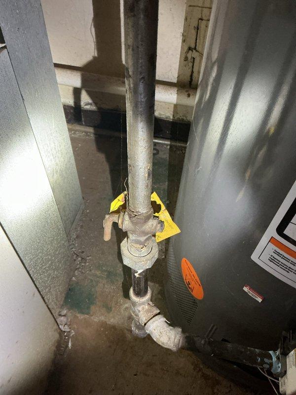 Responded to no hot water complaint at 70-year-old residential property. Upon inspection of basement-installed tanked water heater, diagnosed failed pilot light assembly preventing burner ignition. Verified gas supply to unit, inspected thermocouple and pilot assembly for proper function. Relit pilot flame following manufacturer specifications, confirmed burner ignition cycle, and tested temperature and pressure relief valve operation. Verified all supply and return connections, expansion tank mounting, and flue venting integrity. Restored hot water service throughout residence.