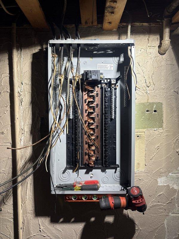 Completed 100-amp electrical panel upgrade in basement utility area. Installed new panel enclosure with dual-row circuit breaker configuration and copper bus bar system. Permit was requested for the installation, and work was performed to prepare electrical service for upcoming HVAC system installation.