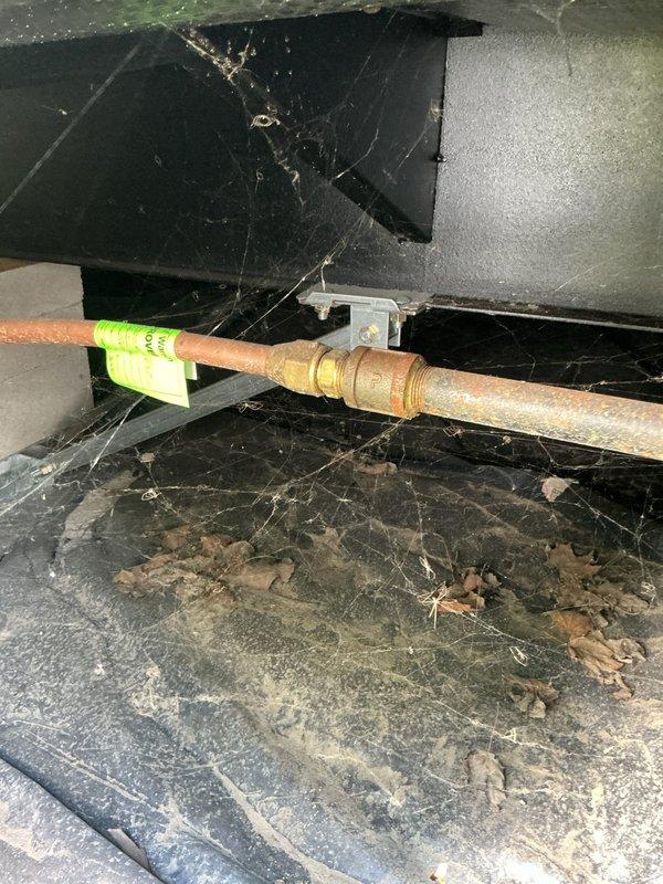 Responded to exterior gas line break affecting specific area of property. Accessed crawl space beneath structure where corroded copper gas line was located. Inspected damaged section of horizontal gas line showing significant oxidation and surface deterioration. Repaired broken gas line section, replaced corroded piping, and secured new line with proper mounting brackets. Tagged repaired section per safety protocols. Verified system integrity and tested for leaks upon completion.