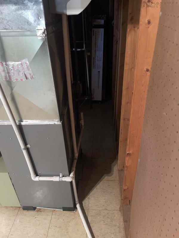 Provided comprehensive estimate for complete HVAC system replacement of aging R-22 air conditioning unit and existing furnace located in basement utility area. Assessed current equipment configuration including gray metal air handler with PVC condensate drainage and evaluated mechanical room layout to determine optimal replacement specifications for modern, efficient system.