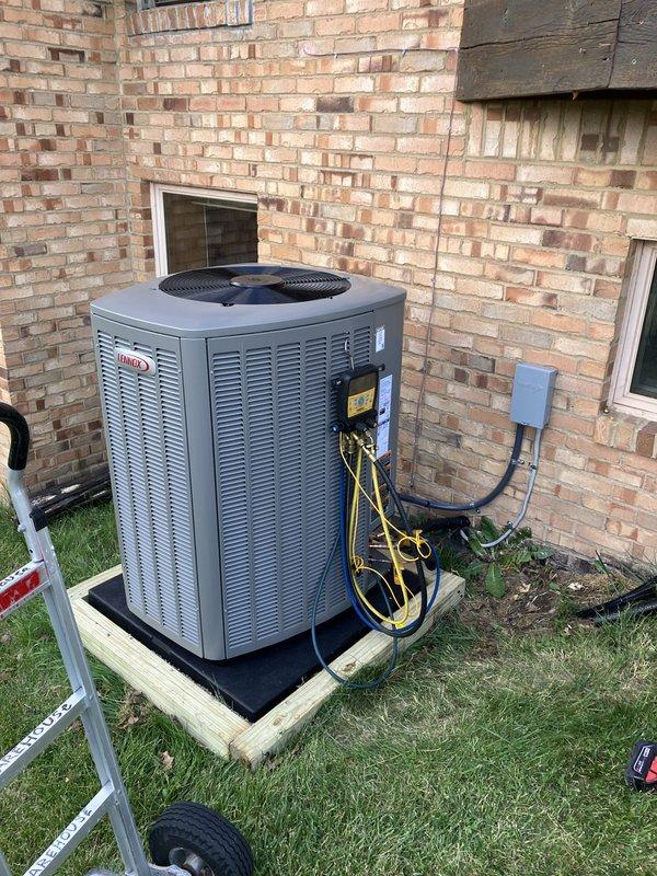 Completed full HVAC system replacement including installation of 110,000 BTU furnace and 4-ton Lennox air conditioning unit in left side yard location. Unit mounted on wooden platform base with rubber isolation pad against exterior brick wall. Connected yellow and black refrigerant lines, installed gray electrical disconnect box, and completed all electrical reconnections per code. Mechanical, electrical, and furnace permits obtained and work inspected. System registered with AHRI certification number for utility rebate qualification. Technician returned for follow-up visit to provide thermostat operation instruction and ensure customer comfort with new system controls.