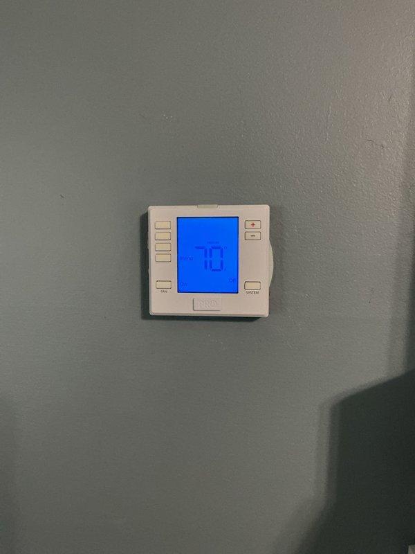 Responded to no cooling complaint on 4-year-old residential air conditioning system. Upon arrival, verified thermostat set to cooling mode at 73°F with no cold air delivery throughout home. Proceeded to outdoor condensing unit for inspection. Found condenser coil heavily restricted with dirt, dust, and debris accumulation between fins, significantly reducing airflow and heat transfer capability. Noted beginning stages of corrosion at base of unit with minor rust spots present on cabinet. Restricted airflow was causing inadequate heat rejection and preventing proper system operation. Cleaned condenser coil thoroughly to restore proper airflow and system efficiency. Verified unit operation after cleaning with proper cooling restored to residence. System covered under existing warranty.