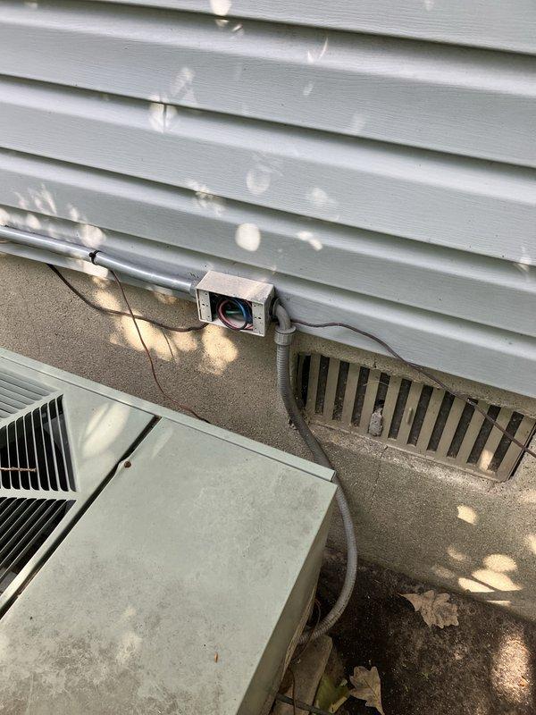 Provided estimate for complete HVAC system replacement including air conditioning condenser unit and natural gas furnace located in basement. Current 10+ year old equipment is non-operational. Site assessment included evaluation of existing outdoor condenser unit on concrete pad, refrigerant line set routing along exterior wall, electrical disconnect, and interior thermostat system currently displaying safety mode at 42°F with indoor temperature reading of 69°F.