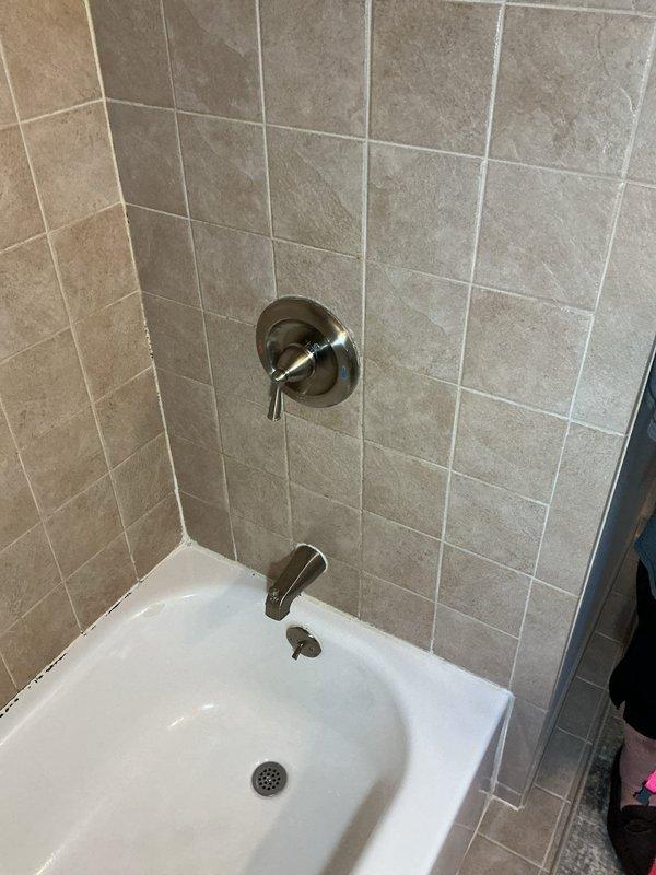 Performed complete hot water tank flush on basement-located unit to remove sediment buildup. Replaced shower faucet handle and showerhead in bathroom with updated chrome fixtures, ensuring proper water flow and temperature control. Replaced worn bathroom sink seats to eliminate leaks and restore proper valve function. All plumbing fixtures tested for proper operation and verified leak-free performance upon completion.