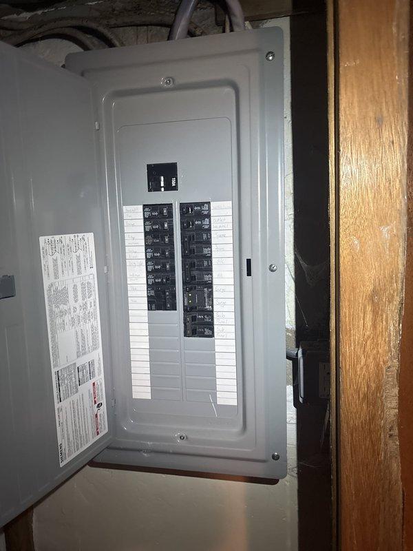 Responded to service call for non-functioning air conditioning system. Upon arrival, tested thermostat operation and confirmed AC unit failed to start. Performed voltage diagnostics at contactor and discovered no output voltage present. Conducted further electrical testing at outdoor disconnect box and identified abnormal voltage reading of only 25 volts on one leg of the power supply, indicating a significant electrical supply issue upstream of the HVAC equipment. Inspected main electrical panel and outdoor disconnect components. Documented findings with photographs of both the outdoor AC disconnect box mounted on exterior wall and the interior electrical breaker panel. Determined that the low voltage condition requires electrical service to diagnose and repair the power supply issue before HVAC system can be restored to operation.