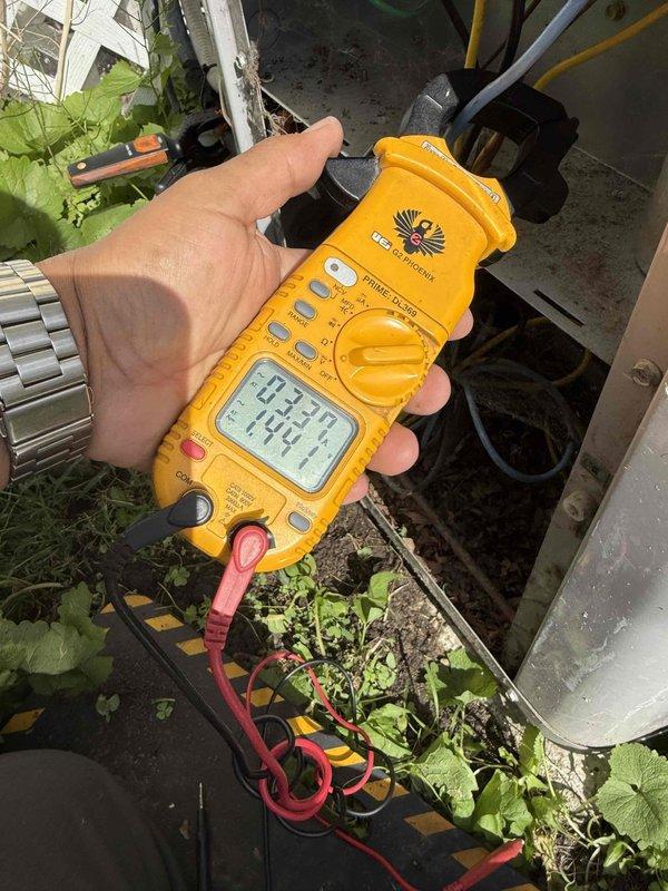 Responded to no cooling complaint with indoor temperature at 78° despite thermostat set to 70°. Performed comprehensive gold-level inspection on 30+ year old air conditioning system with outdoor condensing unit located at rear of property and air handler/coil assembly in basement. Utilized digital multimeter to test electrical components and measure system performance parameters. Inspected condensate drain line and PVC plumbing connections for proper drainage function. Documented system condition and diagnostic findings with photographs for service records.