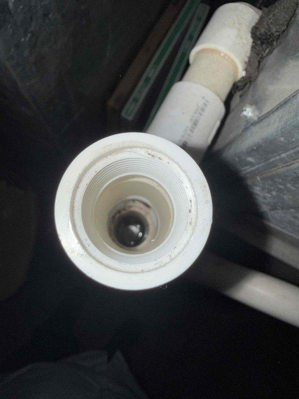 Responded to no cooling complaint with indoor temperature at 78° despite thermostat set to 70°. Performed comprehensive gold-level inspection on 30+ year old air conditioning system with outdoor condensing unit located at rear of property and air handler/coil assembly in basement. Utilized digital multimeter to test electrical components and measure system performance parameters. Inspected condensate drain line and PVC plumbing connections for proper drainage function. Documented system condition and diagnostic findings with photographs for service records.