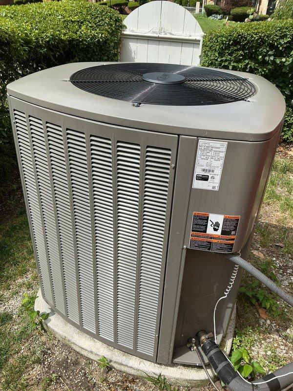 Completed comprehensive Gold AC Inspection on a 3-year-old residential air conditioning system with air handler located in basement. Performed full system evaluation including inspection of outdoor condensing unit on concrete pad, verified proper refrigerant line insulation, checked electrical connections and safety labels, and assessed Bradford White water heater in utility space. All equipment found operating normally with no immediate service needs identified, system components in good condition for age of unit.