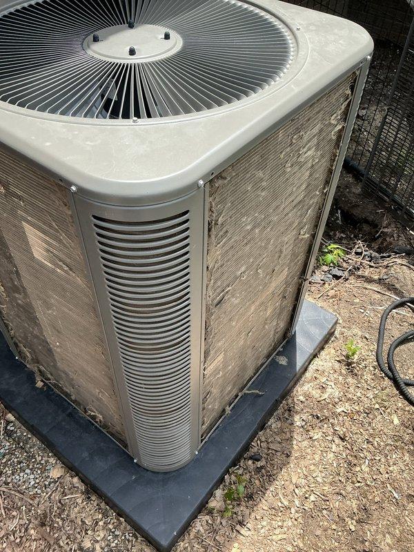 Responded to no-cooling complaint with water leakage from basement air handler on 2-year-old system. Inspected outdoor condenser unit and confirmed proper fan operation and external component condition. Documented equipment condition with photos showing weathered but functional condenser with normal wear patterns for age and exposure. System requires further diagnostic evaluation of indoor evaporator coil and drain line to address water discharge issue and restore cooling capacity.