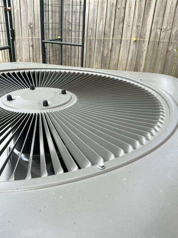 Responded to no-cooling complaint with water leakage from basement air handler on 2-year-old system. Inspected outdoor condenser unit and confirmed proper fan operation and external component condition. Documented equipment condition with photos showing weathered but functional condenser with normal wear patterns for age and exposure. System requires further diagnostic evaluation of indoor evaporator coil and drain line to address water discharge issue and restore cooling capacity.