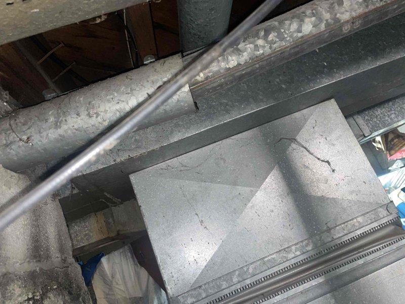 Completed estimate for furnace replacement in basement location. Existing 60-year-old furnace system evaluated with assessment of current ductwork, plenum connections, and venting configuration. Documented existing installation including aged insulated ductwork with visible wear, galvanized metal plenum with surface deterioration, and surrounding mechanical infrastructure to provide comprehensive replacement recommendations and specifications.