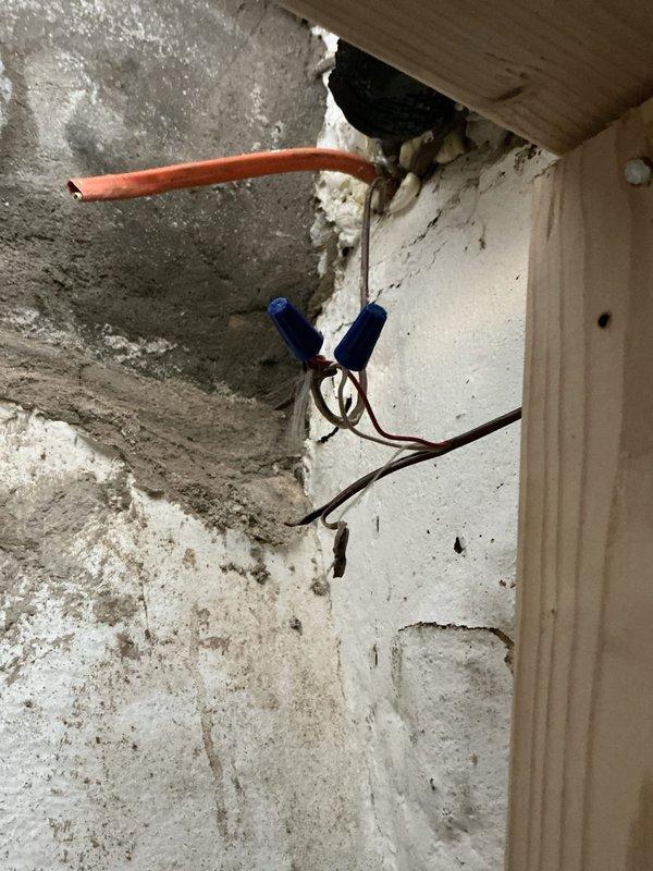Responded to no cooling complaint on 2-year-old basement AC unit where fan operated but no cold air delivered through vents. Upon inspection, discovered compromised refrigerant line connections and improper electrical wiring at the air handler location. Repaired copper refrigerant piping penetrations, secured loose electrical connections with proper wire nuts, and verified system operation. Unit now cooling properly with adequate airflow through all registers.