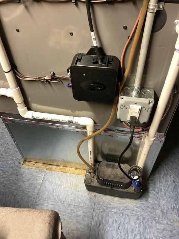 Completed installation of 2.5-ton air conditioning system with uncased evaporator coil in left-side configuration. Reconnected electrical and mechanical systems to existing ductwork in basement utility area. Installed condensate pump with PVC drain lines and verified proper operation of all components. Permits requested for mechanical, electrical, and air conditioning work per code requirements.