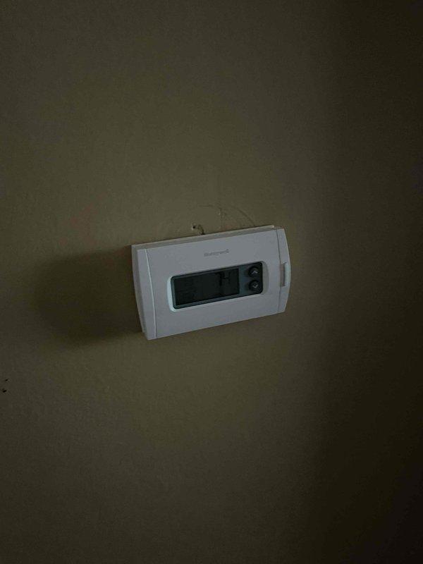 Provided estimate for replacement of non-operational air conditioning system and aging natural gas furnace located in basement. Existing furnace exhibits extensive rust and corrosion on exterior panels and blower compartment, indicating advanced deterioration and end of serviceable life. Current thermostat displaying abnormal reading requires replacement with new equipment installation.