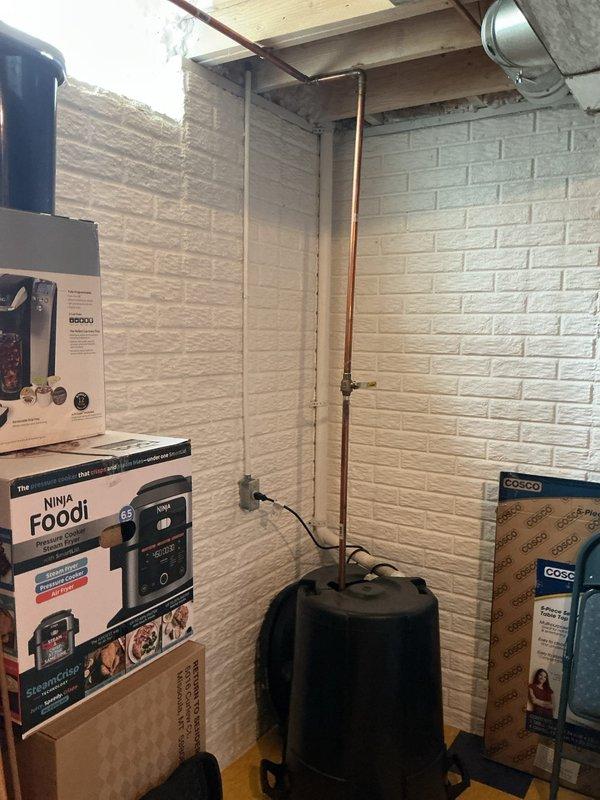 Completed full HVAC system installation including 110,000 BTU furnace and 4-ton air conditioning unit configured for left-side installation. Installed humidifier, base assembly, and high-velocity package system with proper reconnection of all utilities. Verified condensate drain assembly with PVC piping and secured all connections, confirmed proper drainage function, and documented installation with photographic evidence showing drain pan configuration and completed basement installation area.