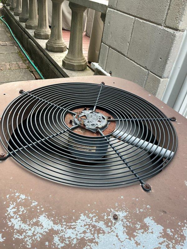 Completed Gold-level preventive maintenance inspection on two air conditioning systems: an 8-year-old unit and a 10+ year-old unit with coil located in basement. Both systems were operational at time of service. Performed comprehensive inspection of outdoor condenser units, including visual assessment of fan assemblies, protective grilles, and housing conditions. Documented extensive weathering and paint deterioration on exterior surfaces of rooftop-mounted unit, with significant peeling and flaking noted on housing while structural components and fan guard remained intact. Verified proper fan operation and airflow on both condensing units. All systems confirmed functioning within normal operating parameters upon completion of inspection.