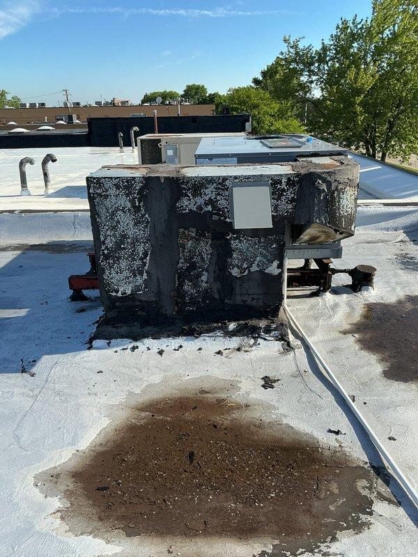 Performed yearly maintenance on rooftop RTU unit and conducted comprehensive leak search on associated ductwork. Upon arrival, accessed roof via ladder and inspected equipment, discovering significant exterior deterioration on primary RTU unit with extensive coating degradation and visible rust-colored staining on roof membrane beneath unit, indicating potential water intrusion. Completed thorough inspection of ductwork system to identify source of reported leak, examined all accessible connections, seams, and penetrations. Documented equipment condition with photographic evidence showing advanced weathering and corrosion on unit casing. Performed standard maintenance procedures including filter inspection, electrical connection verification, and operational testing of RTU components. Identified areas requiring immediate attention due to compromised exterior surfaces and potential water damage to roofing substrate. Provided recommendations for equipment repair and preventive measures t
