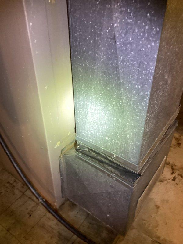 Conducted full system estimate for furnace and air conditioning replacement. Inspected existing Lennox furnace and air handler unit, noting significant dust accumulation on ductwork and plenum chamber, heavy condensation on air handler panel indicating active operation, and overall aging equipment condition. Documented current system configuration including ductwork connections, drain pan placement, and copper refrigerant lines. Photographed equipment to assess replacement requirements and provide comprehensive estimate for complete HVAC system upgrade.