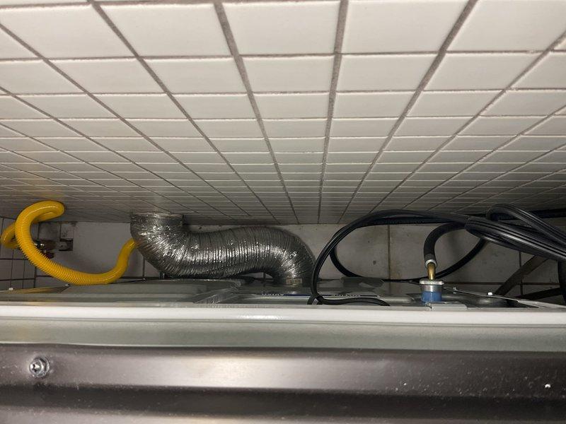 Completed installation of new gas dryer in residential laundry room of 25-year-old home. Connected gas supply line using approved flexible corrugated stainless steel connector with proper fittings and leak testing. Installed metallic flexible exhaust duct venting system routed through ceiling space to exterior termination point, ensuring proper airflow and code compliance. Verified all connections secure, tested gas line for leaks, and confirmed dryer operational with proper venting.