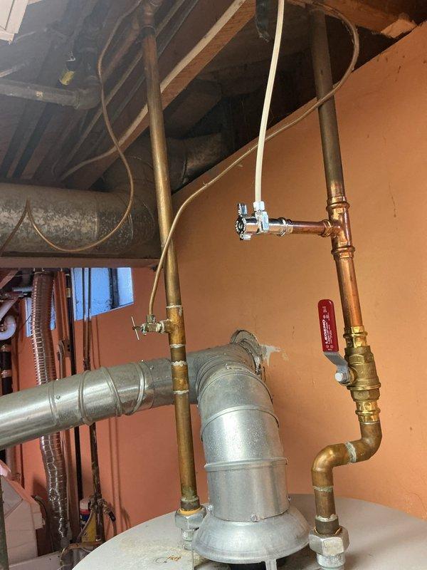 Completed full replacement installation of 40-gallon gas water heater due to faulty gas valve preventing hot water production. Installed new unit with drip pan and alarm system for leak detection and safety compliance. Reconnected all gas lines, water supply connections, and venting system to manufacturer specifications, restoring full hot water service to the property.