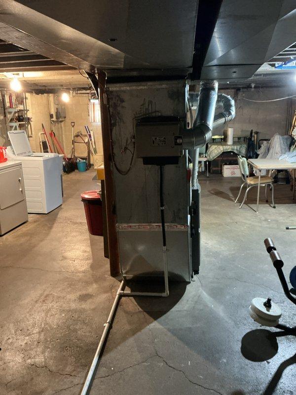 Completed comprehensive Gold AC inspection on a 3-year-old residential HVAC system with basement-located air handler and humidifier unit. Performed visual inspection of furnace cabinet, ductwork, and all accessible components including copper refrigerant lines, electrical connections, and control systems. Verified proper operation of all equipment, documented system condition through photographic records, and confirmed unit is functioning within normal parameters with no immediate service needs identified.