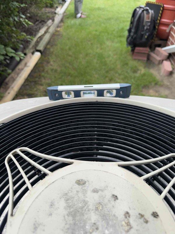 Completed annual cooling maintenance on a 16-year-old Bryant air conditioning system. Performed comprehensive tune-up including inspection of condenser unit, verification of proper leveling, cleaning of fan guard and coil assembly, and testing of all system components. System confirmed operational and functioning properly with no issues identified.