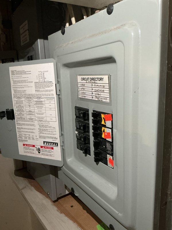 Conducted on-site electrical assessment for new whole home generator installation at manufactured home. Evaluated existing electrical panel configuration, documented main breaker capacity and individual circuit layout, and photographed circuit directory to determine load requirements and compatibility for generator integration with current electrical system.
